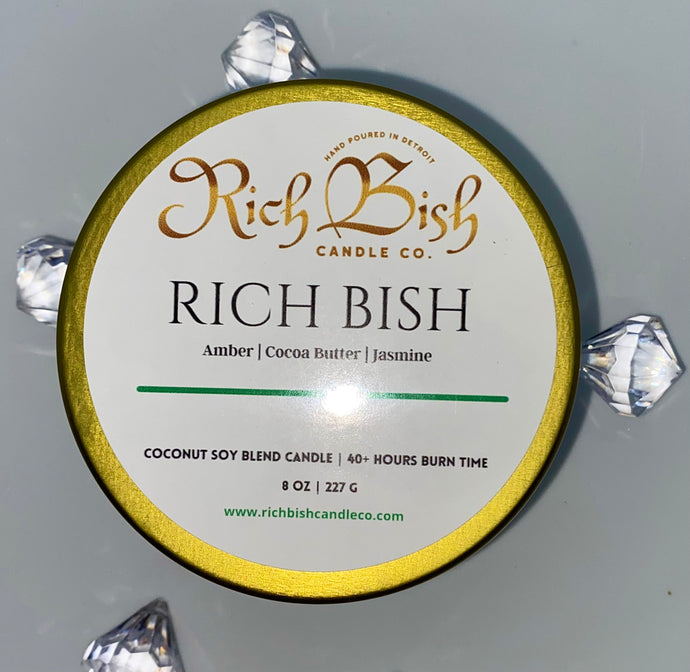 Rich Bish luxury coconut soy 8oz candle in marble metal tin with lid. Candle features fragrance notes of amber, cocoa butter, and jasmine. Best seller