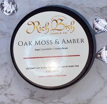 Load image into Gallery viewer, Rich Bish Candle Co&#39;s &quot;Oak Moss and Amber&quot; 8oz coconut soy wax blend candle in a sleek metal tin with lid. Top fragrance notes are sage, lavender, and tonka bean. 
